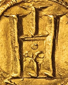 Il presunto giglio o fiordaliso entro la porta genovese sulla moneta precedente