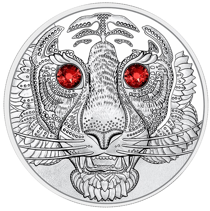 Due cristalli di color rosso intenso sottolineano sul bel rovescio della moneta austriaca la forza dello sguardo della tigre